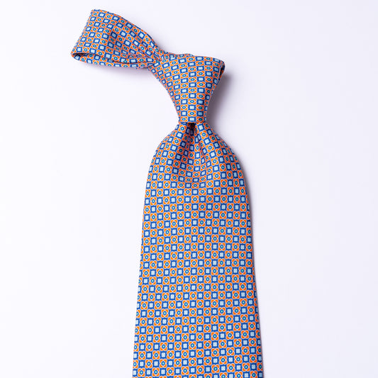 Silk tie with orange/blue floral pattern.