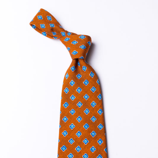 Orange tie with blue floral pattern